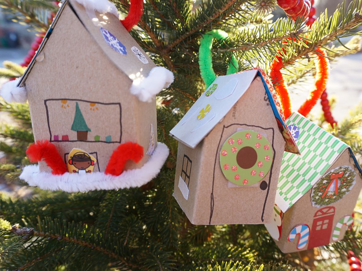 paper christmas house ornaments hanging in tree