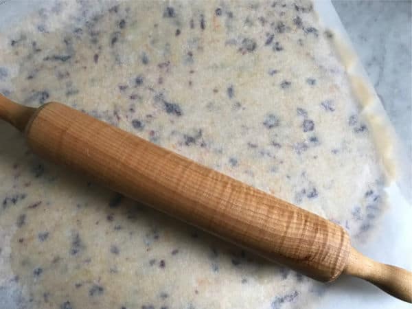 shortbread dough rolled between parchment paper