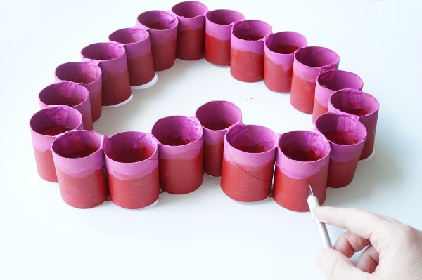 cutting slit in top of toilet paper roll heart to hang on door