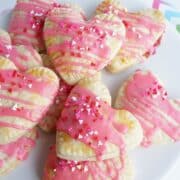 white plate with many valentine heart pop tarts with strawberry filling