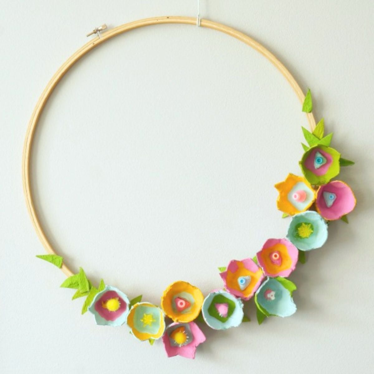 close up egg carton flower wreath made from embroidery hoop