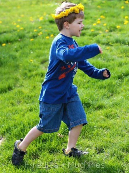 child running in the grass wearing a diy dandelion crown