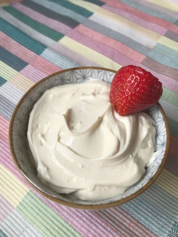 fruit dip in a small bowl with single strawberry