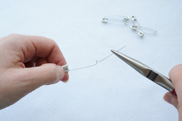 pliers with safety pin completely open and stretched out