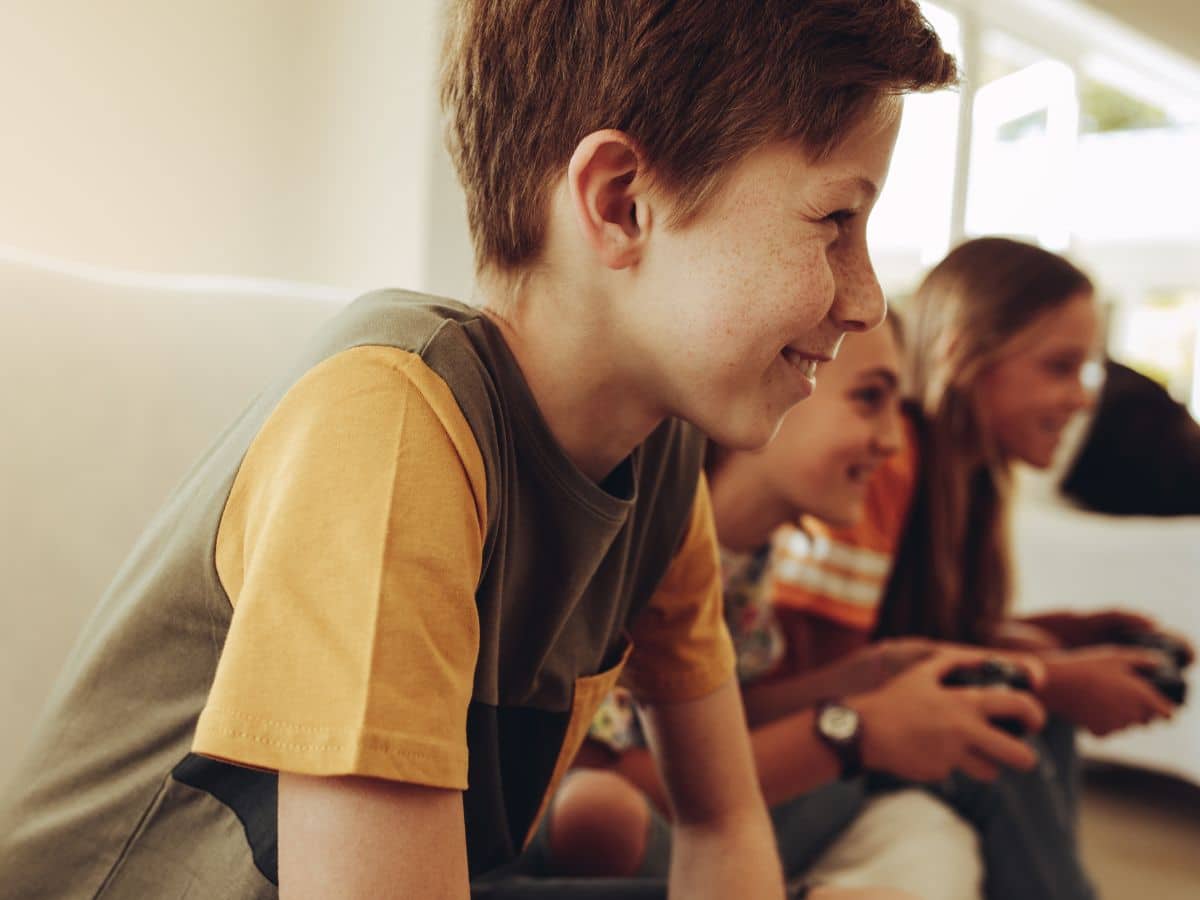 tween boy and tween girls playing video games