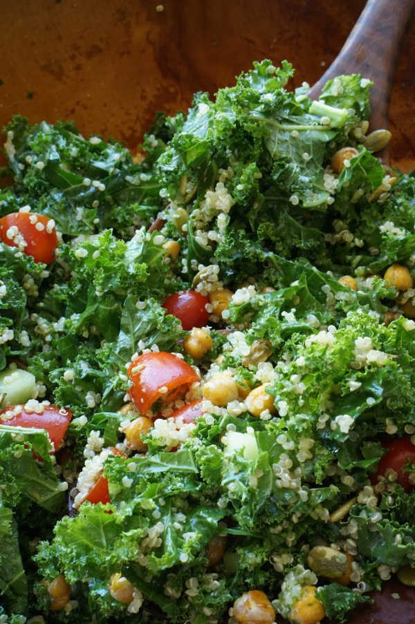 kale salad with crispy chick peas tossed in bowl