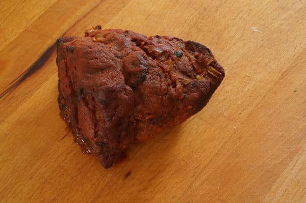cooked pulled pork on cutting board