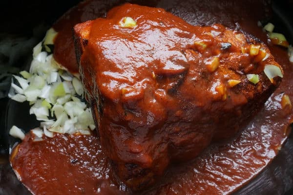 pulled pork with sauce in the slow cooker