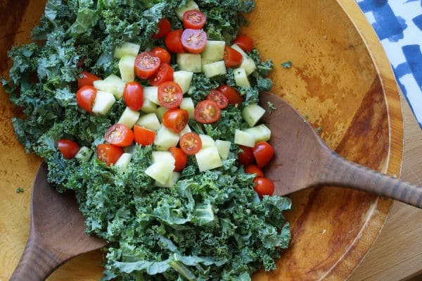 kale, tomatoes and cucumbers in big salad bowl