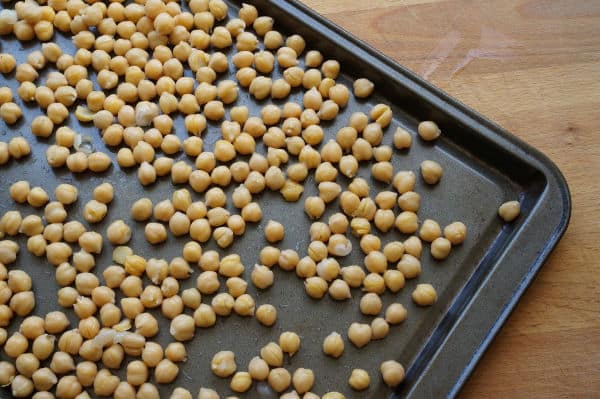 uncooked chick peas on baking sheet
