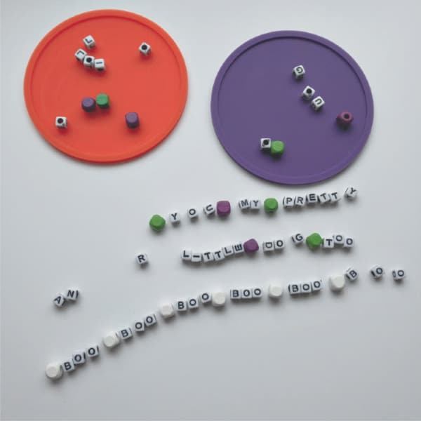 letter bead laid out on table for halloween friendship bracelets