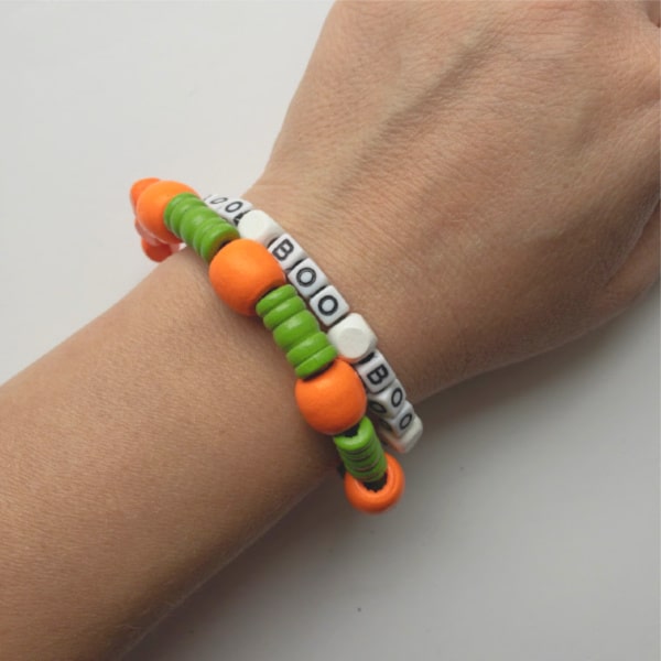 Pumpkin bracelet and ghost bracelet on arm