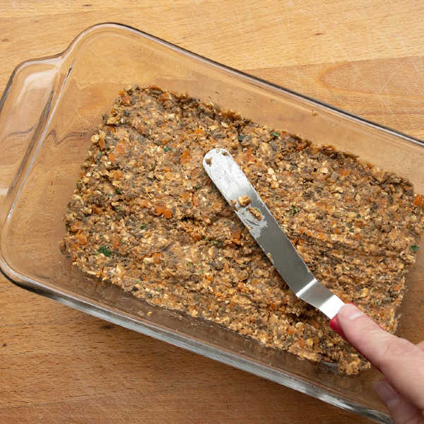 meatless meatloaf being pressed into loaf pan