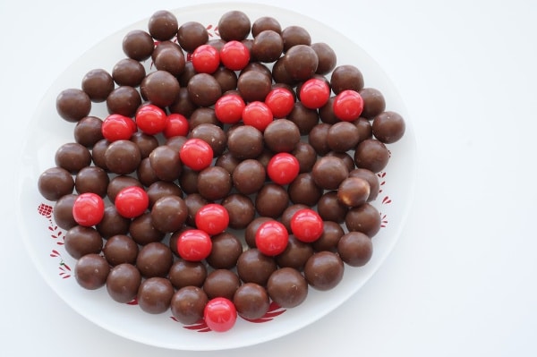 chocolate malt balls and red pom poms