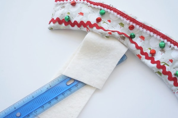putting the felt lining inside the cup cozy with a ruler