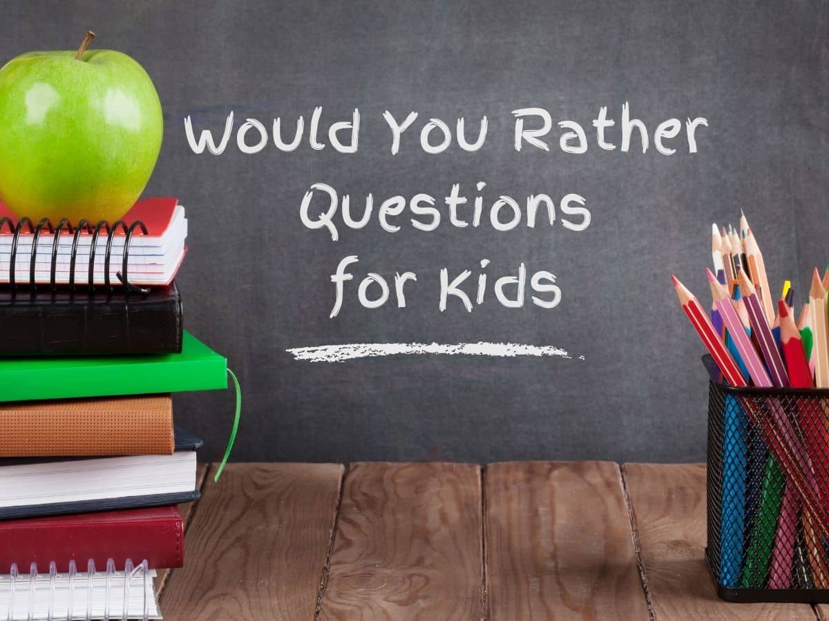 would you rather questions for kids written on chalkboard with cup of pencil crayons and pile of books and apple