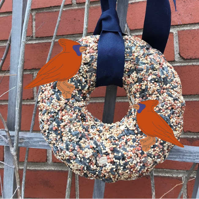 birdseed wreath hanging outside with cardinals on it