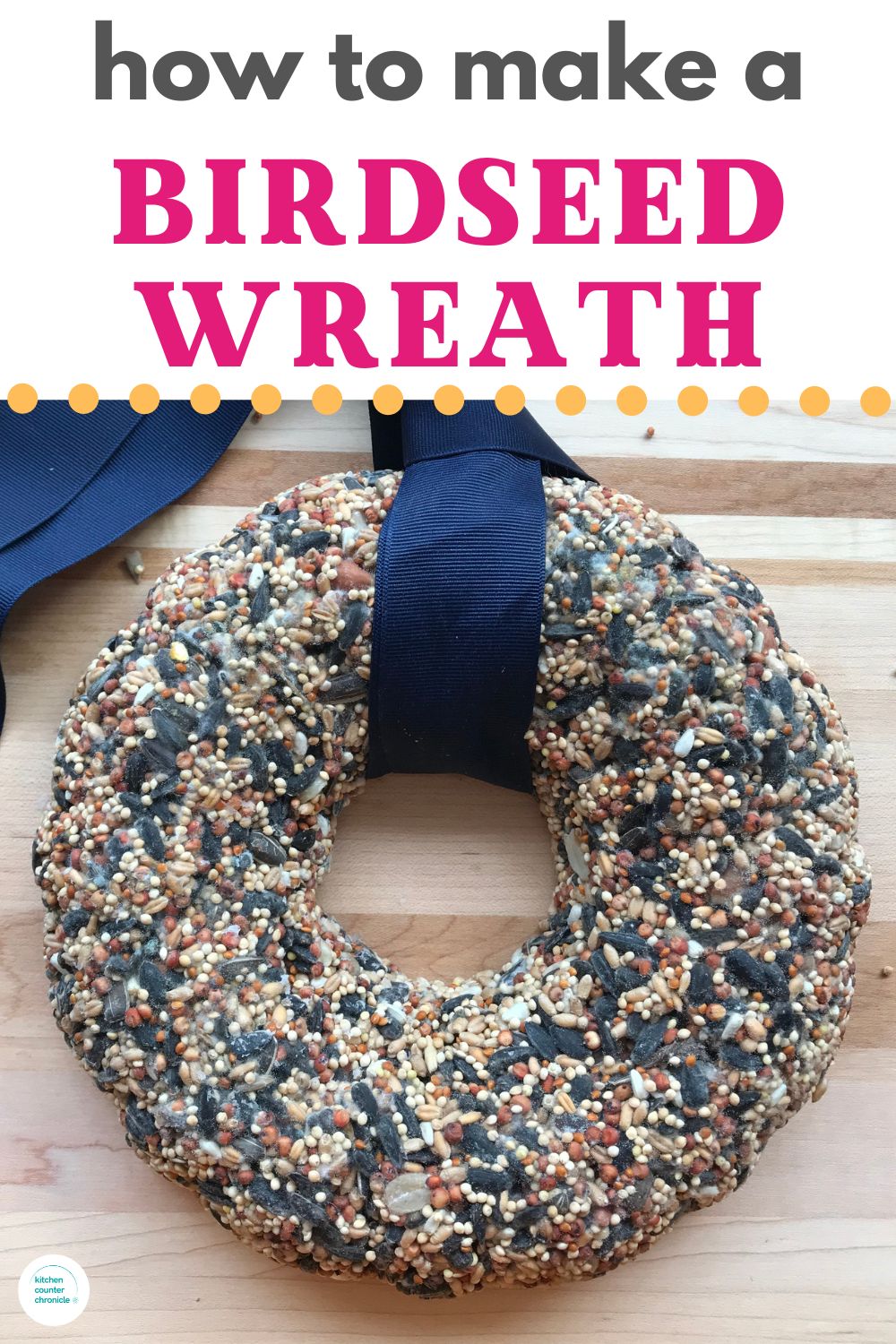 title "how to make a birdseed wreath" with image of a large birdseed wreath wrapped with blue ribbon resting on wooden table.