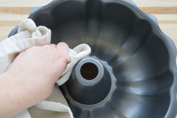 rubbing olive oil into bundt pan for birdseed wreath