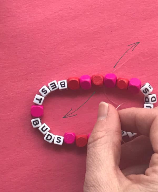 tying knot in stretch thread bracelet