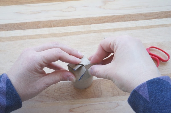 folding the bottom of a toilet paper roll pot for plants