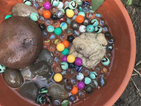 bee bath marbles and rocks and water in bath