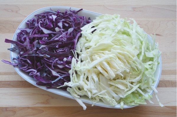 thinly sliced purple and green cabbage on plate