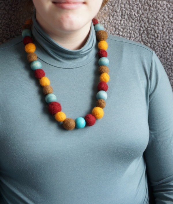 felt ball necklace on girl