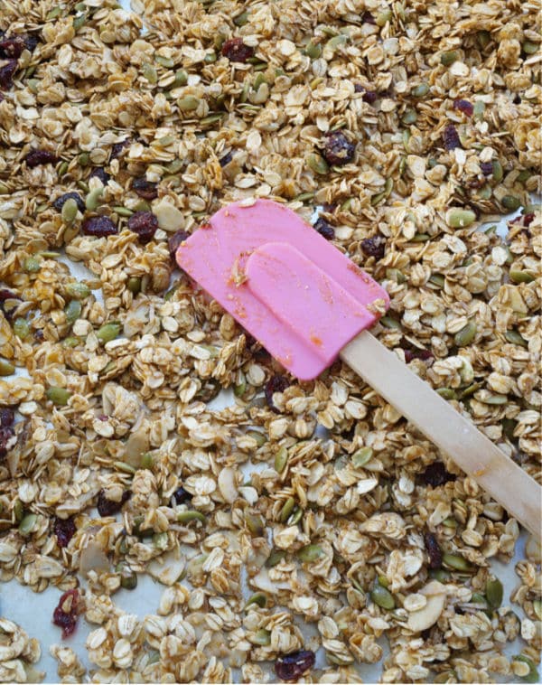 unbaked pumpkin spice granola spread on baking sheet