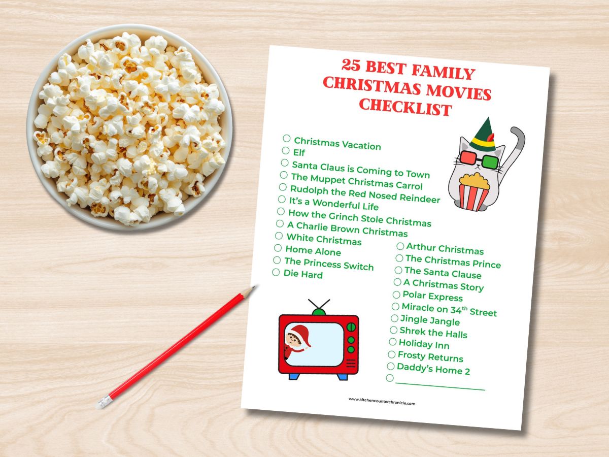bowl of popcorn with print out of 25 best family christmas movies checklist