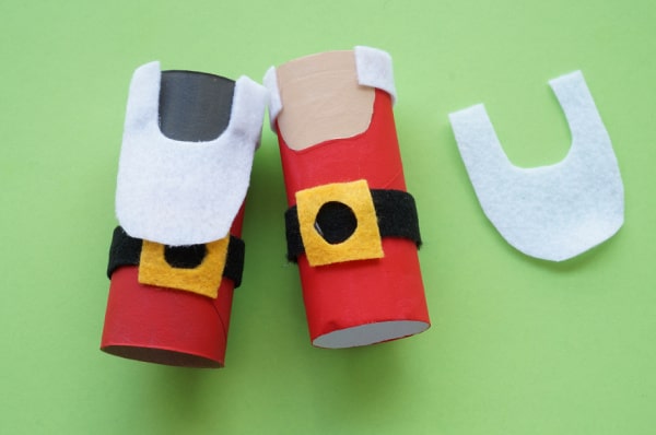 toilet paper roll santas with felt beards and hair glued in place