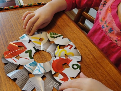 child's paper snowflake displayed on table