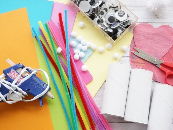 love bug craft supplies with toilet paper rolls on table