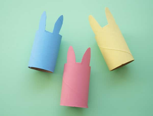 three paper roll bunny painted pink blue and yellow