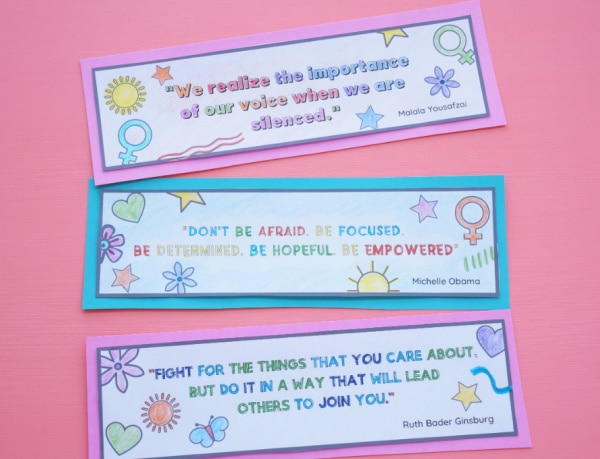 three women's quotation bookmarks coloured in and cut out on table