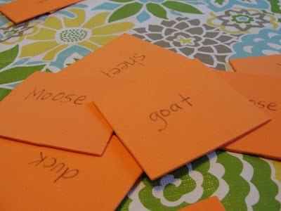 pile of animal matching memory game cards with names of baby and mama animals