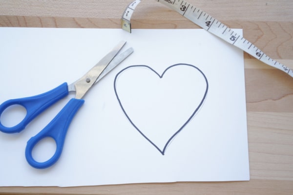 heart drawn on paper with scissors and tape measure