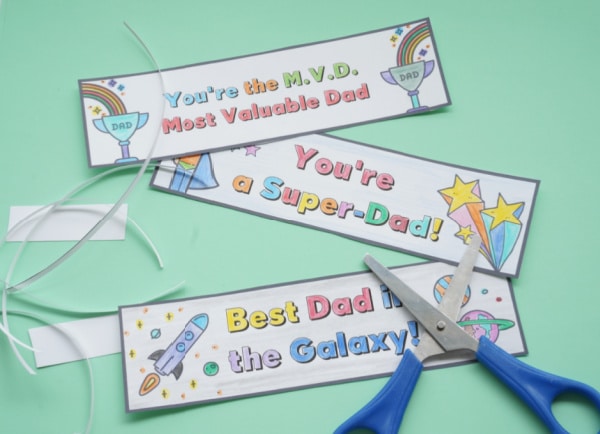 printable fathers day bookmarks cut out with scissors on table