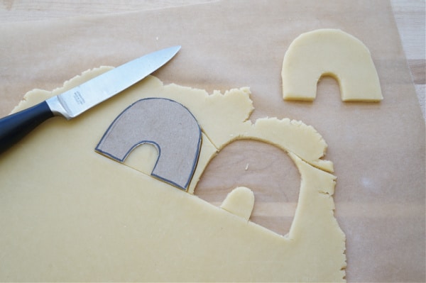 rainbow cardboard cookie cutter cut out of dough