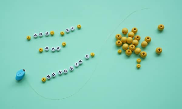 letter beads and yellow beads with stretchy thread
