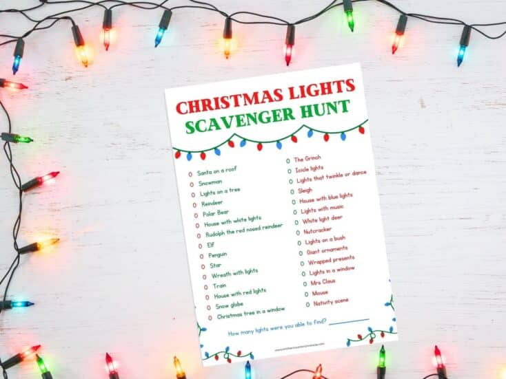 christmas lights scavenger hunt printed out on a table with christmas lights