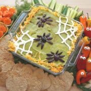 halloween vegetable tray with 7 layer dip and pumpkin tortilla chips