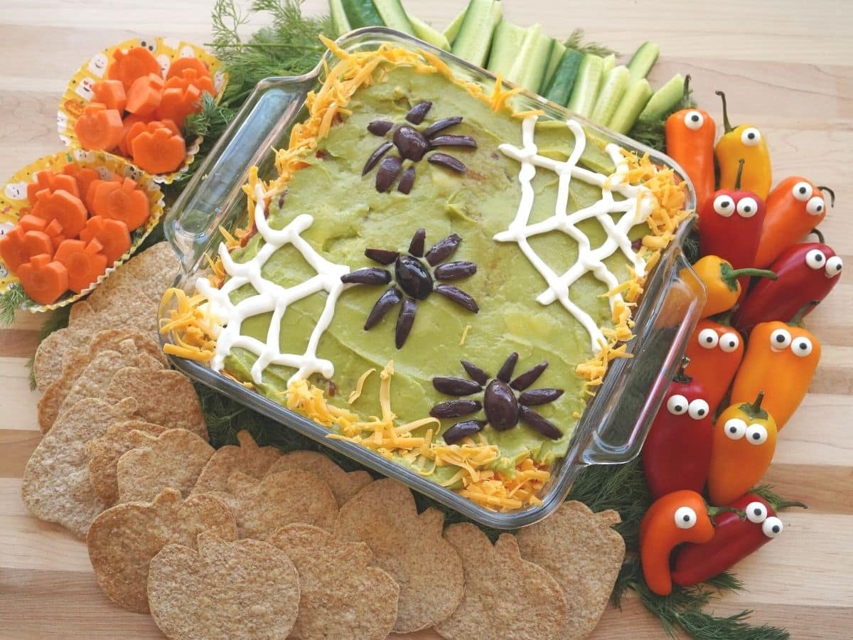 halloween vegetable tray with 7 layer dip and pumpkin tortilla chips