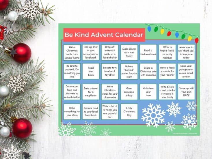 kindness advent calendar printed out on table with pine branches