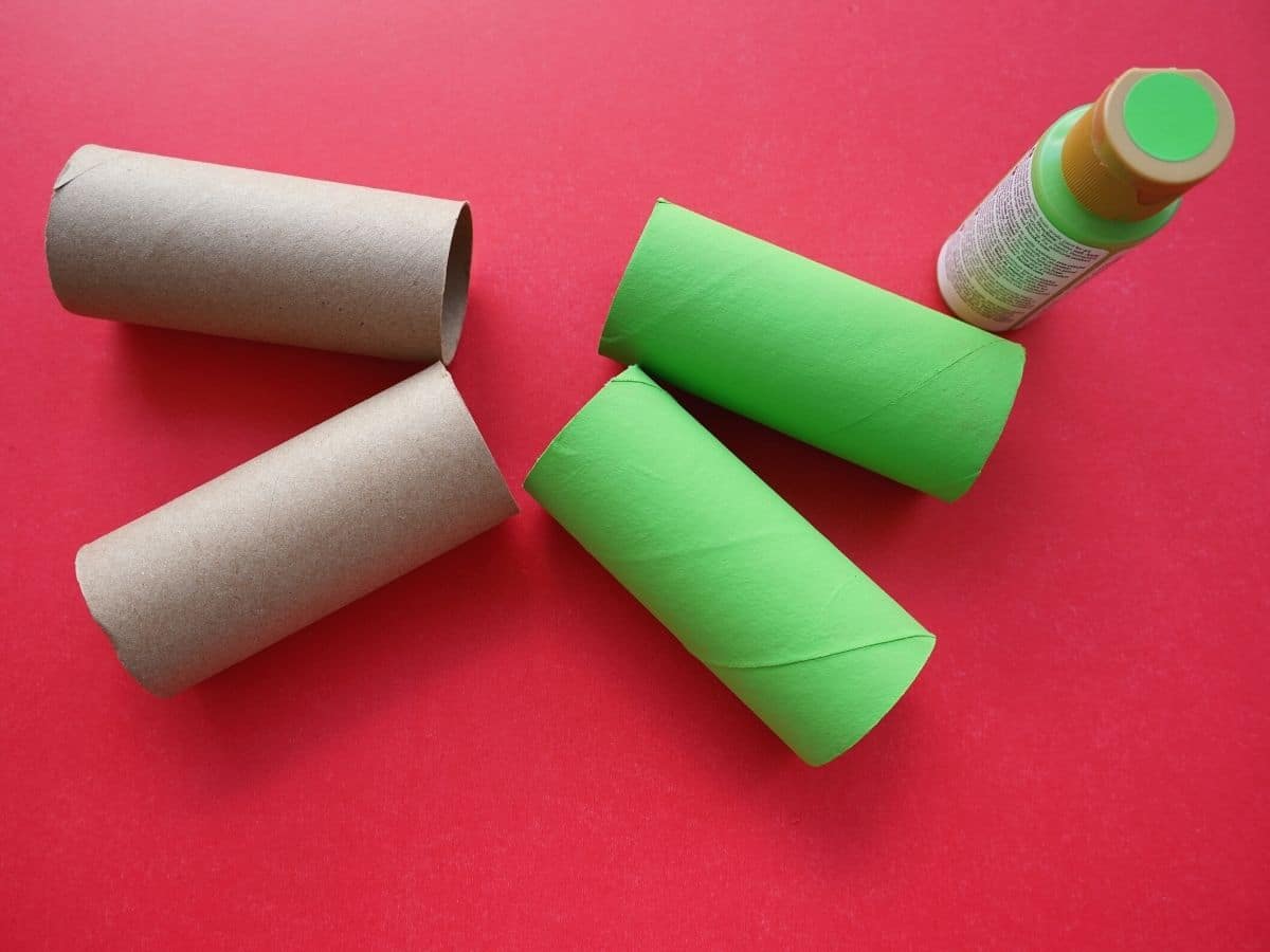 grinch green painted toilet paper rolls with bottle of paint
