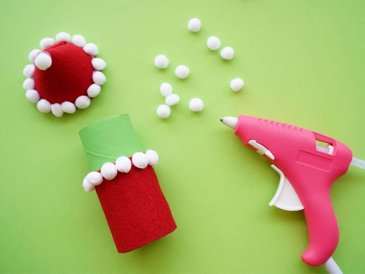 grinch toilet paper roll with pom pom trim glued on