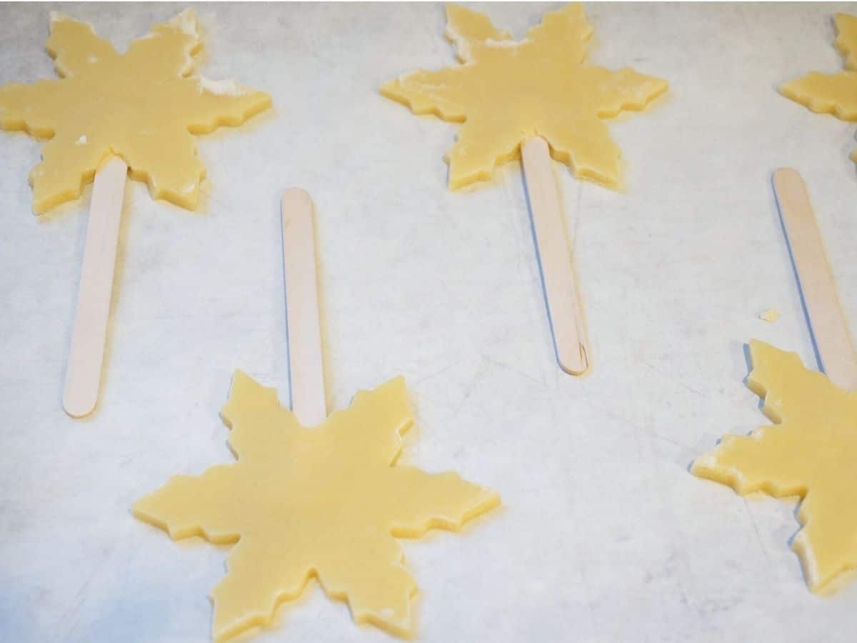 snowflake christmas cookies unbaked on baking sheet