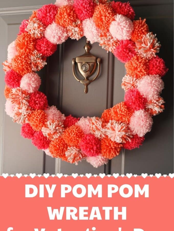 diy valentines pom pom wreath hanging on door
