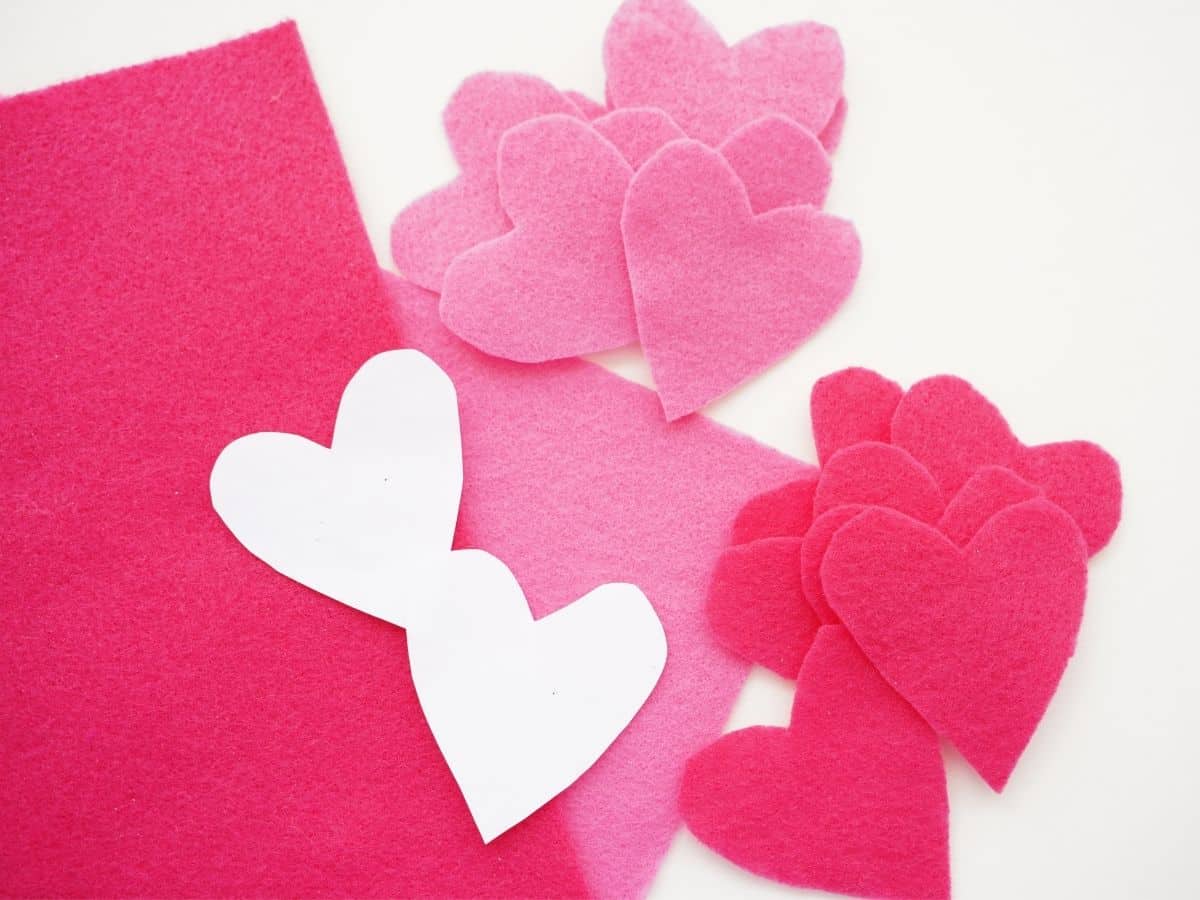 pile of pink felt hearts and paper heart templates