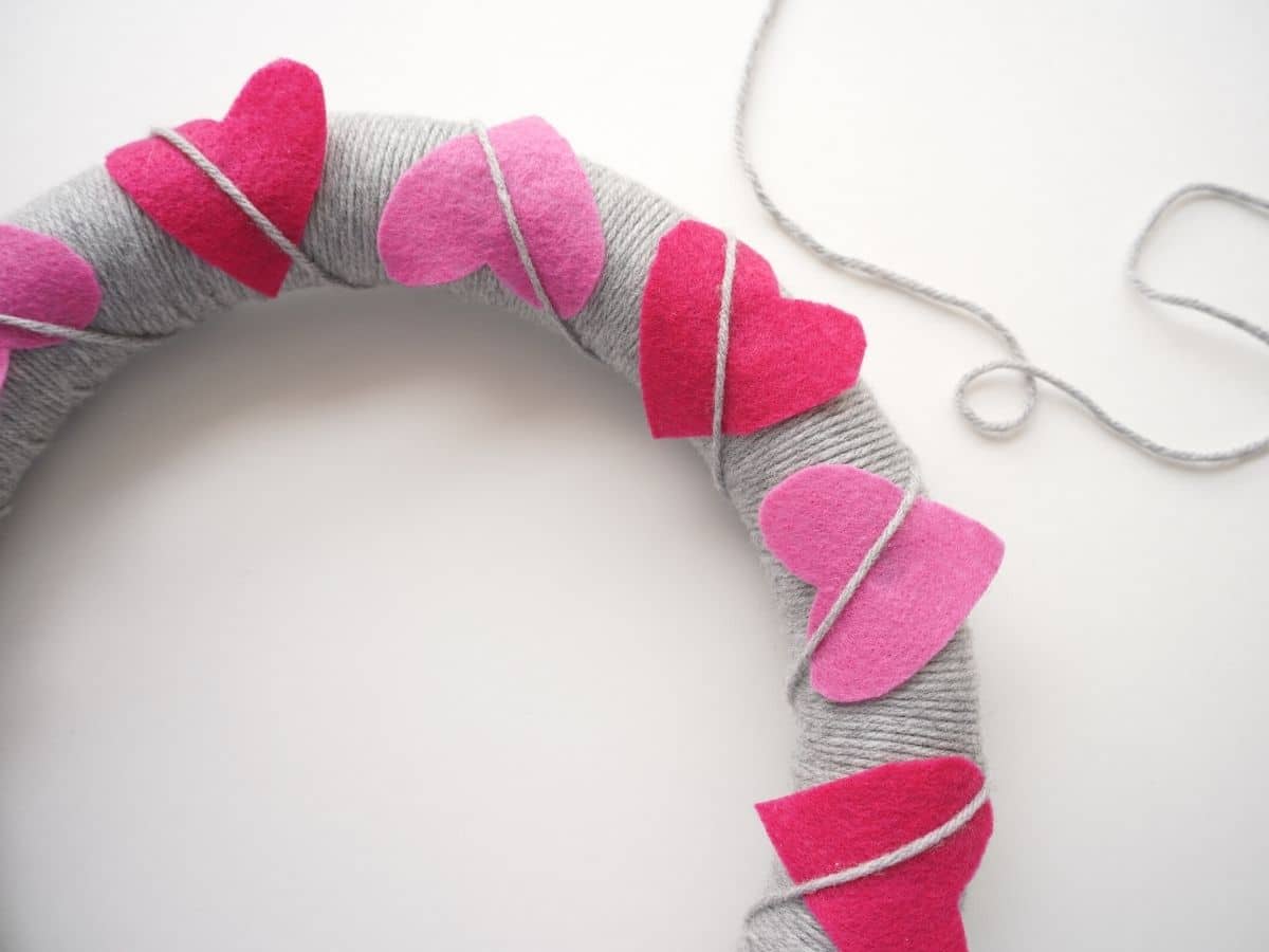 pink felt hearts wrapped diagonally with grey yarn